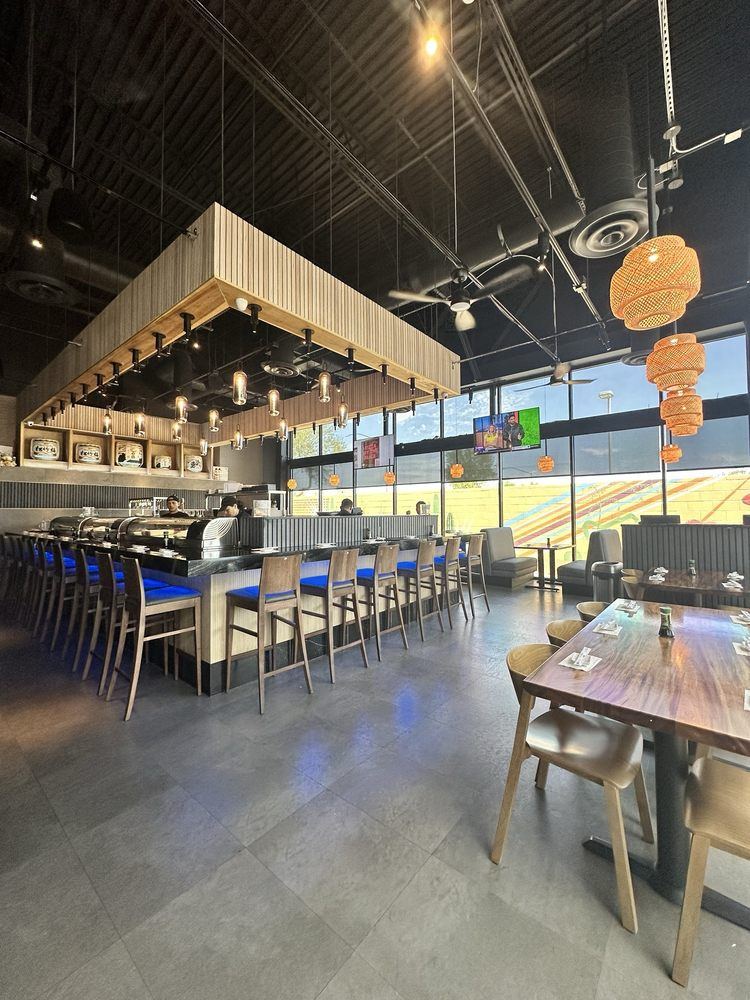 The Scottsdale dining room with a long sushi bar, blue bar stools and wood tables
