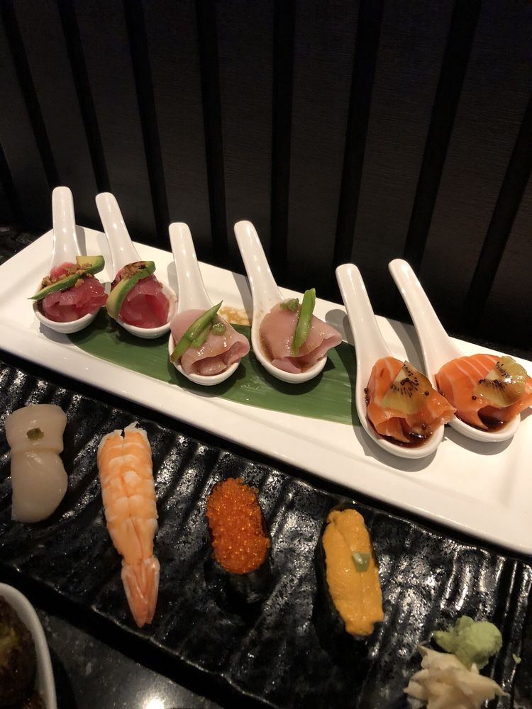 Tunacado, yellow grapefruit and kiwi salmon tapas spoons above scallop, shrimp, ikura and uni nigiri